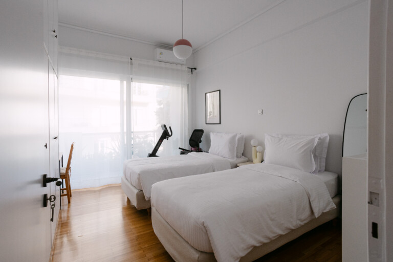 Twin bedroom with two single beds and exercise bike