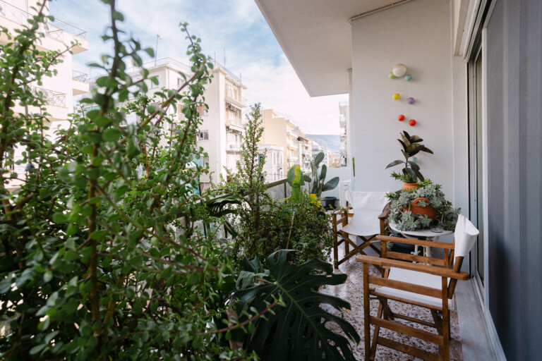 Plant-filled balcony with outdoor seating