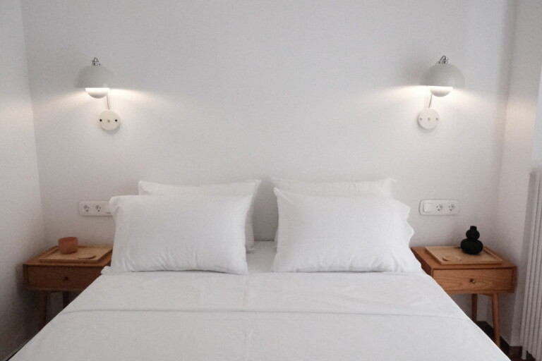 King-size bed with white linen and bedside lamps