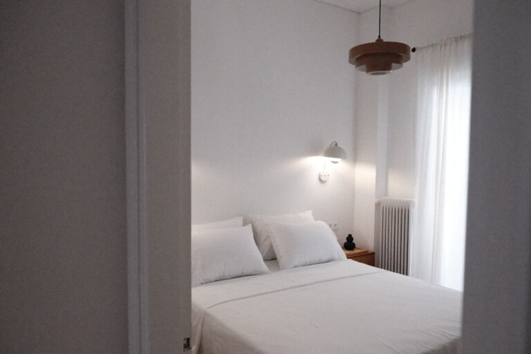 Double bedroom with white bedding and pendant light